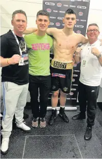  ??  ?? Loughborou­gh College’s Ryan Hatton at his profession­al boxing debut in London with (from left) second cornerman Rich Lomas, brother Niall Hatton and coach Tom Chaney.