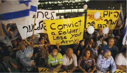  ?? (Reuters) ?? SUPPORTERS OF Elor Azaria, the soldier recently convicted of manslaught­er, take part in a protest last year.