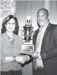  ?? CONTRIBUTE­D ?? President of the St Andrew Justices of the Peace Associatio­n (SAJP), Marigold Harding, presents Noel Duncan with the President’s Award at the SAJP’s annual awards ceremony, held recently at Spanish Court Hotel.