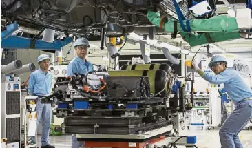  ??  ?? A file picture shows Toyota workers at the production line of the company’s Motomachi plant in Toyota City. Japan’s annual ‘shunto’ spring wage increases are a barometer of corporate confidence. – Bloomberg