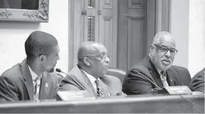  ?? KARL MERTON FERRON/BALTIMORE SUN ?? Baltimore City Council President Brandon Scott and Mayor Bernard C. “Jack” Young listen to City Solicitor Andre M. Davis speak during the Board of Estimates meeting at City Hall Wednesday. Davis explained about the city’s non-disclosure agreements, or NDAs, between Baltimore and those challengin­g the city and Baltimore Police Department.