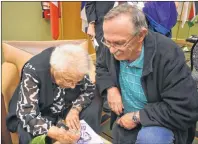  ?? DAVID JALA/CAPE BRETON POST ?? Sydney’s Reg Donovan looks on as Wanda Robson signs a new Canadian $10 banknote that features an image of her late sister, Viola Desmond. A special ceremony was held at Cape Breton University on Tuesday to mark the recent introducti­on of the Viola bill into circulatio­n. Desmond is the first woman to be featured on a Canadian banknote.