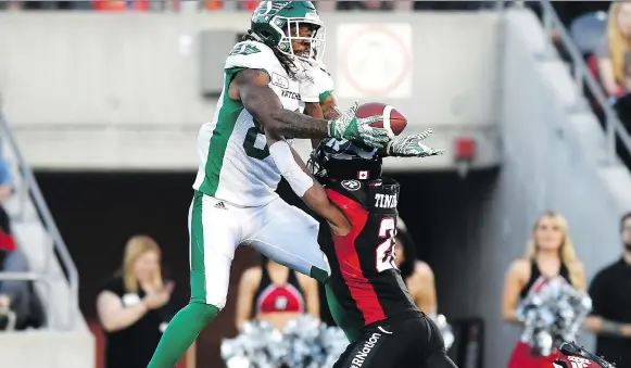  ?? JUSTIN TANG/THE CANADIAN PRESS ?? The Redblacks’ Corey Tindal prevents the Riders’ Naaman Roosevelt from making a catch in the end zone during Thursday’s CFL game in Ottawa.