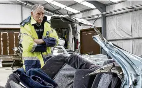  ?? PHOTO: THE NEW ZEALAND HERALD ?? Aftermath . . . Aoraki Area Commander Inspector Dave Gaskin looks over the wreckage of a car which snapped in half in a fatal crash outside Washdyke, in Timaru, last year.