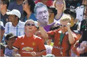  ??  ?? Real Madrid’s Mateo Kovacic (16) takes a shot against a wall of Manchester United players at Levi’s Stadium on Sunday. United prevailed in penalty kicks in the matchup of world powers. Left, A soccer fan celebrates after getting on the jumbotron.