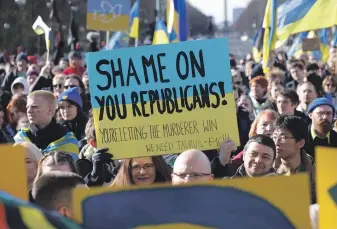  ?? GETTY IMAGES ?? Supporters of Ukraine turn out in Berlin to mark the second anniversar­y of Russia’s invasion, while highlighti­ng the way Republican­s in the US Congress are preventing further US assistance.