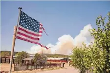  ?? Adria Malcolm/New York Times ?? Smoke rises from the Calf Canyon/Hermits Peak fire in May near Las Vegas, N.M. The effects of climate change are already far-reaching and worsening, according to a government report.