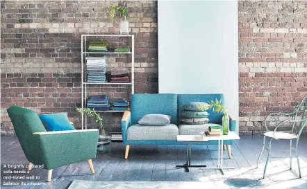  ??  ?? A brightly coloured sofa needs a mid-toned wall to balance its intensity.