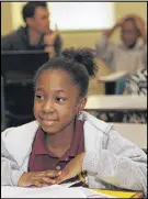  ??  ?? Kadija Marshall, 11, smiles as she works with writer Raven Neely on her story about Martin Luther King Jr. Stories from 28 students will be published in a book.