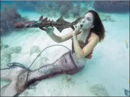  ?? BOB CARE / ASSOCIATED PRESS ?? A festivalgo­er pretends to play a sculpture of an instrument at the Lower Keys Underwater Music Festival in Florida, US, on Saturday.