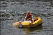  ?? MARIAN DENNIS — MEDIANEWS GROUP ?? A participan­ts paddles her way back after racing in a cardboard boat race on the Schuylkill River.