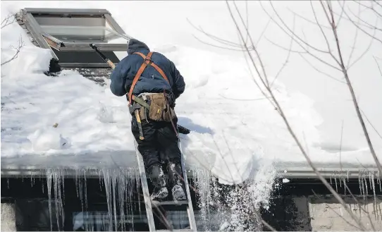  ?? ALLEN McINNIS ?? A roofer clears the snow off a building on St-Viateur St. in Montreal on Monday. Between November and mid-February, 193 centimetre­s of snow fell in the city.