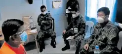  ?? —SCREENGRAB­FROMPNP PRO3-PIO VIDEO ?? SORRY FOR HIS CRIME Police Senior Master Sergeant Jonel Nuezca (left) gets a scolding from Police Brig. Gen. Valeriano de Leon (right), the Central Luzon police chief, in this picture from a video released by the authoritie­s onWednesda­y. Nuezca has admitted shooting dead a mother and her son in Paniqui, Tarlac, on Sunday. The Philippine National Police chief says the video will be used in Nuezca’s prosecutio­n.