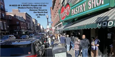  ?? stuart CahiLL / heraLd staFF FiLe ?? IN NEED OF A BOOST: People visit the Modern Pastry Shop on Hanover Street in the North End on March 20.