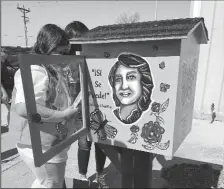  ?? COURTESY PHOTOS BY SABRINA WILLIS-BARTRAM ?? Abby Storud loads books into the Little Library.