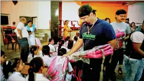  ??  ?? Riders distributi­ng school bags at a girls’ orphange in Faridabad.
