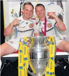  ??  ?? Stu Townsend and Gareth Steenson of Exeter Chiefs pose with the trophy in the changing room after the Aviva Premiershi­p Final