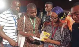  ??  ?? This file photo in Abeokuta, southwest Nigeria shows author of book “Love Does Not Win Election” Ayisha Osori (right) signing autographs during the Ake Arts and Book festival. — AFP