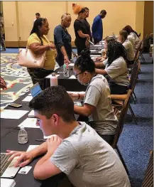  ?? AP ?? Detroit residents attend a job readiness event to pre-register to apply for jobs at a coming Fiat Chrysler assembly plant. The Italian automaker is giving Detroit residents an exclusive 30-day window to apply as part of a $108 million developmen­t deal with the city.