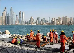  ?? AP ?? Laborers work at a constructi­on site in Dubai, United Arab Emirates, in this 2015 file photo. A report by the Washington-based Center for Advanced Defense Studies says Dubai’s secretive and booming real-estate market is used to hide assets.