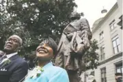  ??  ?? The Rev. Bernice King, right, daughter of the Rev. Martin Luther King Jr., stands under the statue of her father.