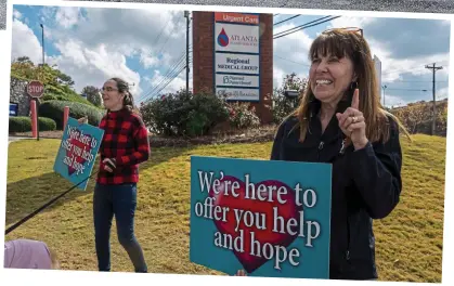  ?? ?? Frontline: An abortion clinic and a ‘pro-life’ centre stand side by side in Columbus, top. Above, Suzanne Guy and her daughter Rachel outside a Planned Parenthood branch in Marietta, Georgia