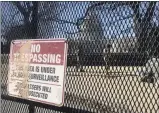  ?? ALAN FRAM— ASSOCIATED PRESS ?? Members of the National Guard stand inside anti- scaling fencing that surrounds the Capitol complex, Sunday, Jan. 10, 2021, in Washington.