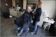  ?? CHARLIE NEIBERGALL — ASSOCIATED PRESS ?? In this March 16 photo, Tom Reiter gets his haircut from stylist Amy Riddle, in Carroll, Iowa. Outside his sprawling Iowa congressio­nal district, Republican U.S. Rep. Steve King’s stream of inflammato­ry comments generate outrage and condemnati­on, but...