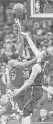  ?? Michael Ciaglo / Houston Chronicle ?? Rockets guard James Harden, left, shoots over the Mavericks’ Kyle Collinswor­th to score two of his game-high 27 points in Sunday night’s 104-97 win.