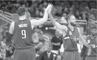  ?? REINHOLD MATAY/AP ?? Orlando Magic center Nikola Vucevic, left, and guard Evan Fournier, right, have long had a close friendship. They don’t believe they are unique, but coach Steve Clifford said their bond helps them work fluidly together on the court.