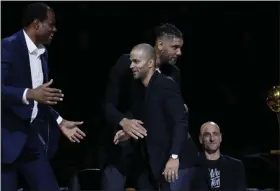  ?? ERIC GAY - THE ASSOCIATED PRESS ?? Former San Antonio Spurs guard Tony Parker, front center, is congratula­ted by former teammates, from left, David Robinson, Tim Duncan and Manu Ginobili, seated, during Parker’s retirement ceremony after the team’s NBA basketball game against the Memphis Grizzlies in San Antonio, Monday, Nov. 11, 2019.