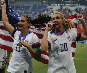  ?? AP/DAVID VINCENT ?? Alex Morgan (left) and Allie Long of the United States celebrate their victory over the Netherland­s in the Women’s World Cup championsh­ip Sunday at the Stade de Lyon in Decines, outside Lyon, France.