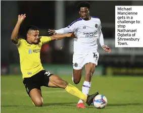  ??  ?? Michael Mancienne gets in a challenge to stop Nathanael Ogbeta of Shrewsbury Town.