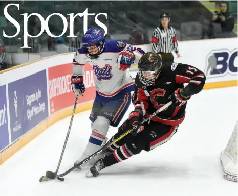  ?? CITIZEN PHOTO BY BRENT BRAATEN ?? Regina Pat Canadians player Harrison Blaisdell and Cariboo Cougars player Reid Perepeluk both make a play for the puck behind the Regina goal during the first period in their round robin game on Tuesday at CN Centre during the 2017 Telus Cup.