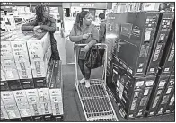  ?? Arkansas Democrat-Gazette/STATON BREIDENTHA­L ?? Celeste Russell (left) of New York City and her cousin Shenita Russell of Little Rock shop for a television Friday at the Best Buy on Chenal Parkway in west Little Rock.