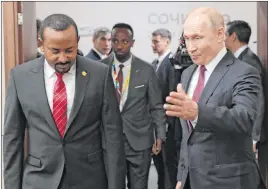 ?? Sergei Chirikov The Associated Press ?? Russian President Vladimir Putin welcomes Ethiopian Prime Minister Abiy Ahmed for talks on the sideline of Russia-africa summit Wednesday in Sochi, Russia.