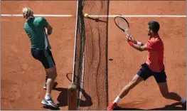  ?? CHRISTOPHE ENA — THE ASSOCIATED PRESS ?? Novak Djokovic, right, plays a shot against Alejandro Davidovich Fokina during their thirdround match of the French Open at the Roland Garros stadium in Paris on Friday.