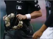  ?? DAVID ZALUBOWSKI — THE ASSOCIATED PRESS ?? Home plate umpire D.J. Rayburn wears a wristband to protest “abusive player behavior” on umpires by players as Rayburn heads to his position to call the first inning of a baseball game between the Milwaukee Brewers and and the Colorado Rockies late...