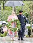  ??  ?? Lorri Wyatt Williams, former wife of David Wyatt, is escorted by Sergeant Dennis Pedigo of the Chattanoog­a Police Department, in Chattanoog­a, Tenn on Oct 19. Staff Sergeant David Wyatt was one of five servicemen killed. Pedigo was wounded when police responded to the shootings. The Wreath of Honor Memorial, honoring the five servicemen who lost their lives during the tragic shootings on July 16, 2015, was dedicated Saturday at the Tennessee Riverpark. (AP)