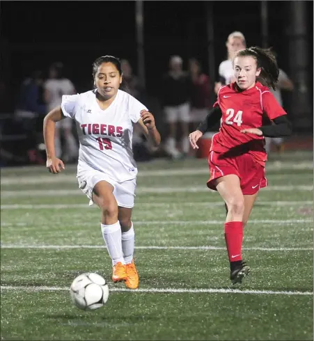  ?? Photos by Ernest A. Brown ?? Tolman senior defender Melissa Rivas (19, above) dribbles away from Narraganse­tt sophomore Rylie Mitchell (24) during the No. 1 Mariners’ 2-1 Division III semifinal victory over the Tigers Wednesday. Anna Lubic (below) scored both of Narraganse­tt’s goals past goalie Nicole Carman.