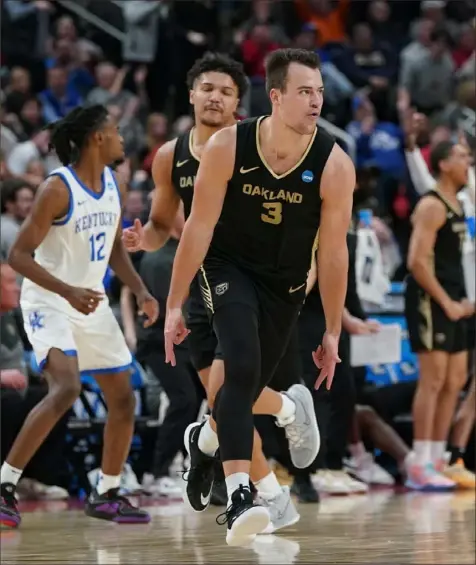  ?? Sebastian Foltz/Post-Gazette ?? Oakland’s Jack Gohlke runs back after hitting yet another 3-pointer Thursday night against Kentucky. Gohlke finished with 10 of them as part of a 32-point game in the upset of the No. 3-seeded Wildcats at PPG Paints Arena.