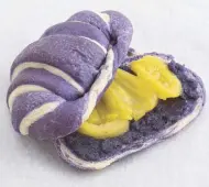  ??  ?? The Ube Langka Croissant has slices of caramelize­d jackfruit and ube halaya spread (sweet taro) in a soft ube croissant.