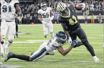  ?? Chris Graythen / Getty images ?? Alvin Kamara of the Saints carries the ball as the eagles’ rasul douglas attempts to stop him.