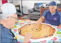  ?? ERIC MCCARTHY/JOURNAL PIONEER ?? Ellsworth brothers, Melvin, left, and Joey practise their centres as they prepare for the provincial Crokinole competitio­n. Crokinole is one of the 22 competitio­ns planned as part of the P.E.I. 55+ Provincial Summer Games from Sept. 20 to 23.