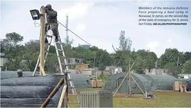  ?? IAN ALLEN/PHOTOGRAPH­ER ?? Members of the Jamaica Defence Force preparing a base camp in Norwood, St James, on the second day of the state of emergency for St James last Friday.