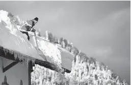  ?? PHILIPP GUELLAND/GETTY ?? Saturday in Kruen, Germany. The snowfall has closed roads, triggered avalanches and cut villages off across southern Germany and much of Austria. At least 21 weather-related deaths have been reported across Europe in the last 10 days.