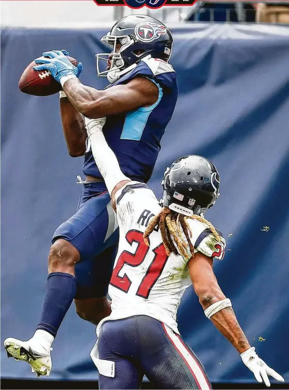  ?? Brett Coomer / Staff photograph­er ?? Titans receiver A.J. Brown leaps over Texans cornerback Bradley Roby for a 7-yard touchdown catch in the final seconds of regulation to send the game to overtime.