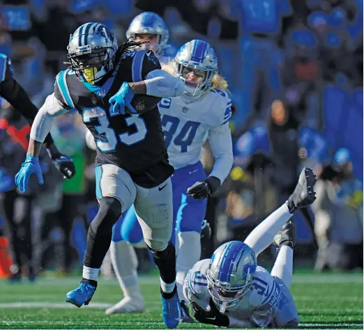  ?? RUSTY JONES/AP ?? The Panthers’ D’Onta Foreman rushed for a career-high 165 yards Saturday against the Lions. The Panthers ran for 320 yards overall.