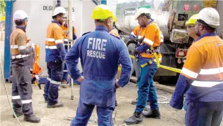  ??  ?? Fulton Hogan Hiway staff and Safety Trainers learning to wear the safety harness under the National Fire Authority Supervisio­n.