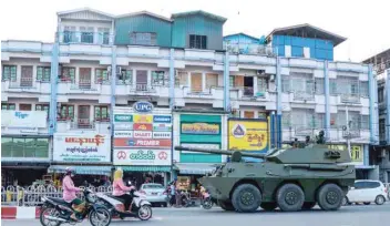  ?? — AFP ?? A military armoured vehicle is seen along a street in Myitkyina, Kachin State, on Tuesday as Myanmar’s generals appeared in firm control of the country.